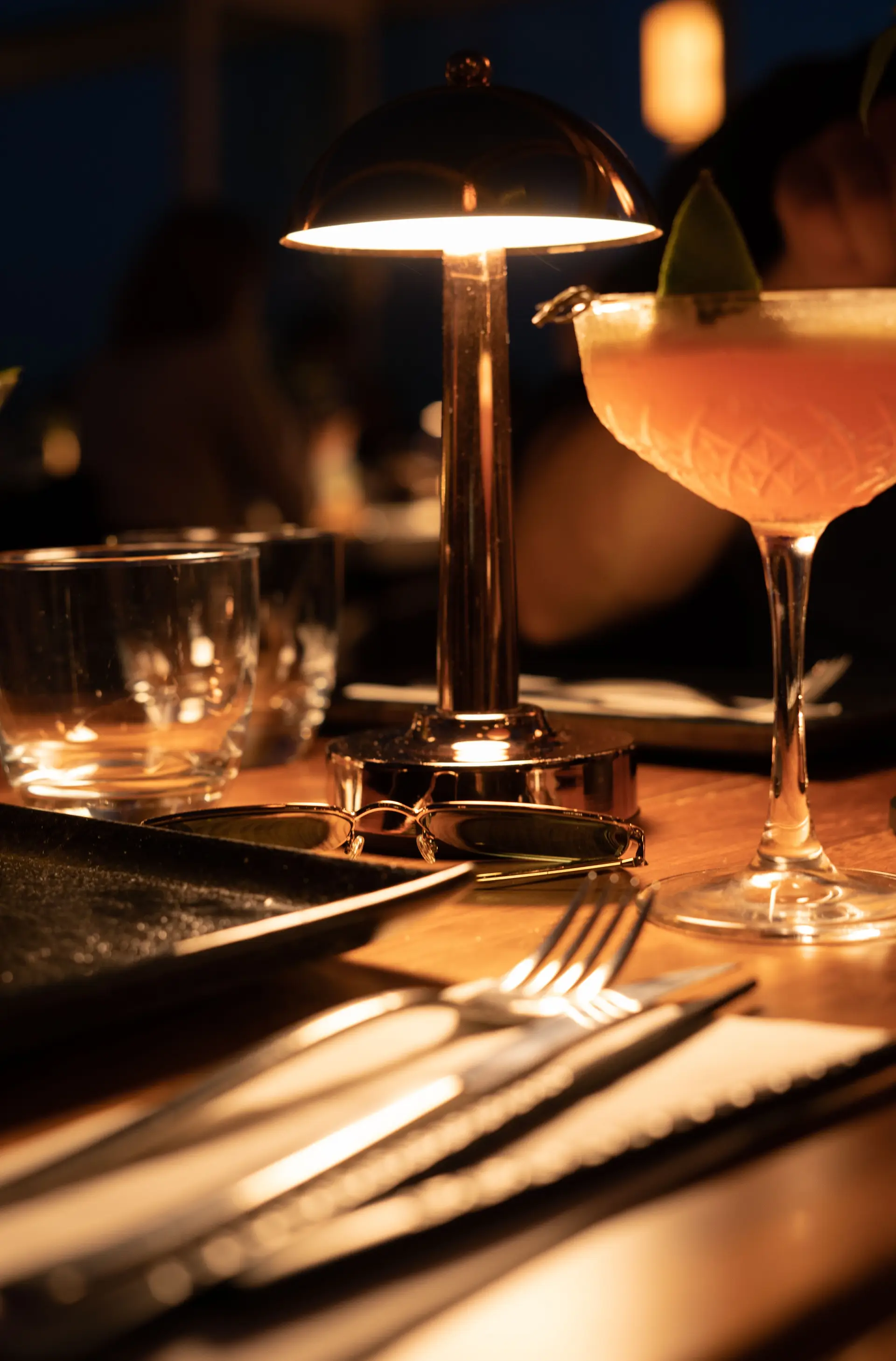 Warmly lit restaurant table prepared for dinner